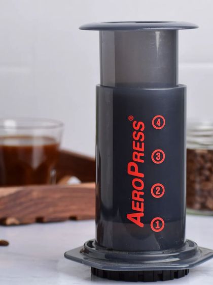 A shot of an AeroPress coffee maker in a clean kitchen setting. We photograph kitchen gadgets and appliances with a focus on their design and function.