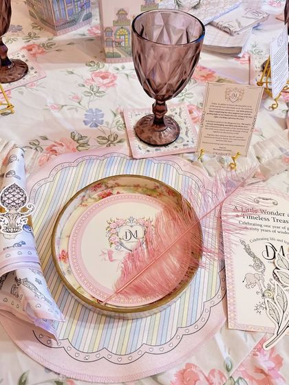 Every place setting tells a part of the story. We designed custom monogrammed plates, illustrated menus, and delicate feather accents to continue the fairytale theme down to the smallest, most personal detail.