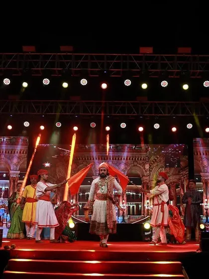 A dynamic stage moment during a cultural performance, with performers in traditional attire. My lighting and LED screen visuals are designed to complement the energy and theme of the act.