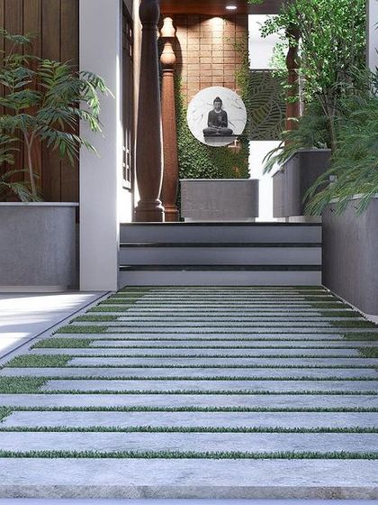 A ground-level view of the pathway, featuring stone slabs interspersed with grass, leading towards the serene entrance.