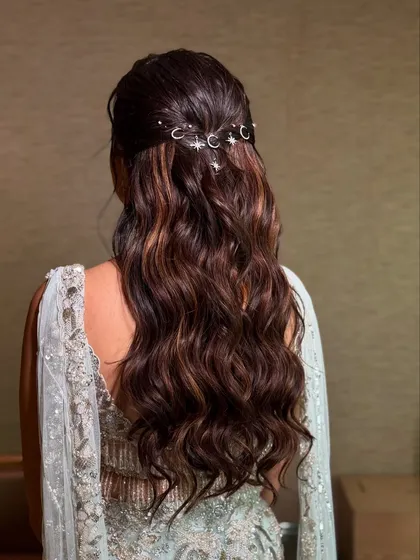 A closer look at the celestial themed half updo. The moon and star charms are carefully placed to create a magical, starry night effect in the hair.