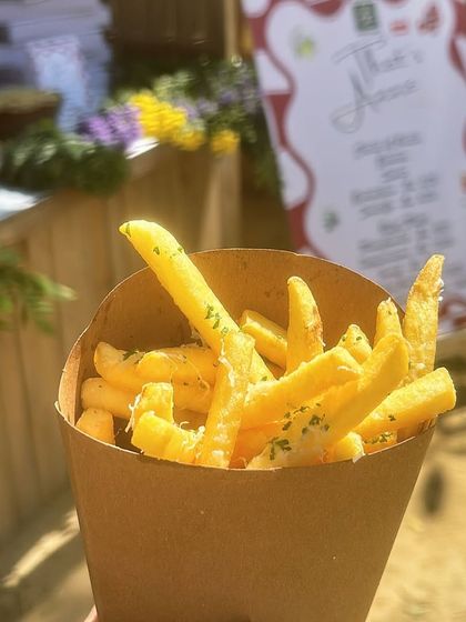 Sometimes the simplest things are the best. I also offer classic sides like these crispy French fries, seasoned with herbs and served in a convenient cone, perfect for kids and adults alike.