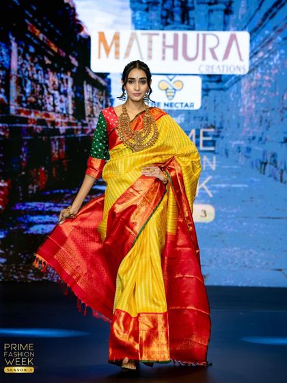 A classic combination of yellow and red takes the runway, this Kanchipuram silk saree is a timeless choice for any bride.