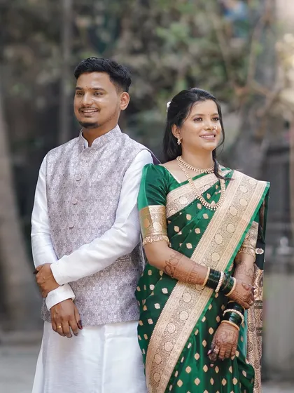 A lovely couple portrait from their engagement day. The bride's makeup is soft and natural, perfectly complementing her traditional green saree and the daytime celebration.