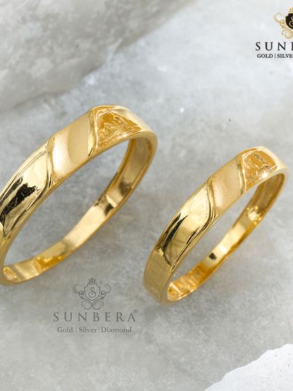 Simple, elegant, and meaningful. This set of couple rings features a clean, polished gold band with a subtle diagonal textured accent, proving that sometimes the most understated designs make the biggest impact.