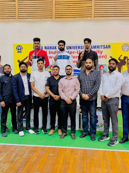 Our team and officials celebrating a successful campaign at the All India Inter-University Taekwondo Championship.