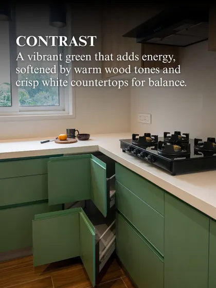 Another view of the sage green kitchen, showing the corner storage solution. The design ensures that every inch of space is utilized effectively, without compromising the clean, modern aesthetic.