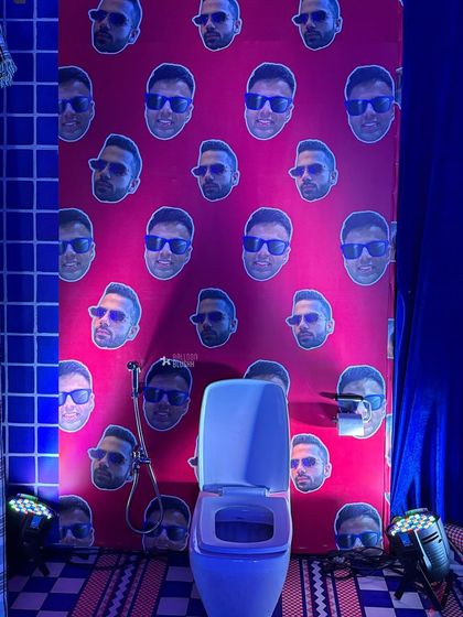 A humorous and personalized detail: the bathroom wallpaper is covered with the birthday boy's face.