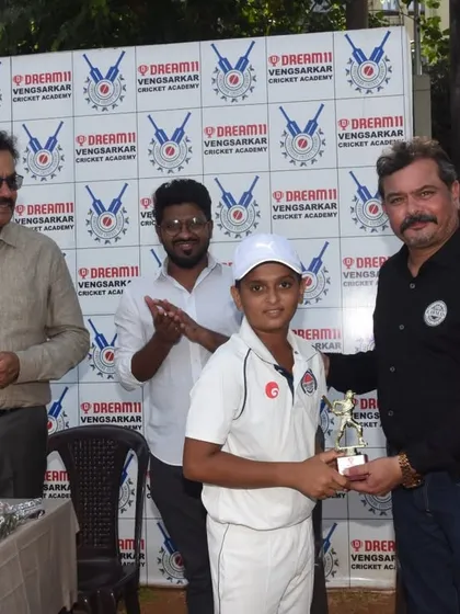 A young cricketer receiving his award at the Dream11 Cup ceremony at Oval Maidan.