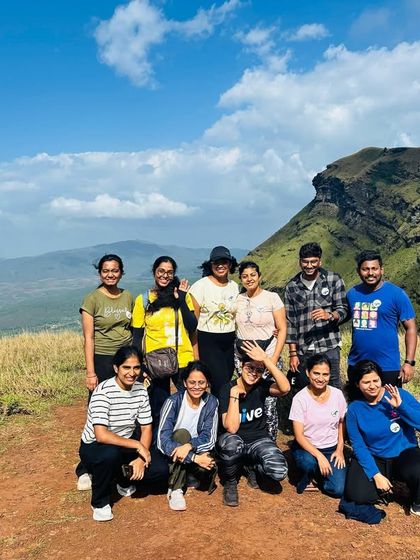A beautiful group photo on a clear day, with the rolling hills and a bright blue sky.
