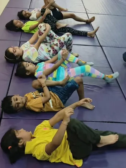 It's all about balancing and stretching. The kids are doing floor exercises to improve their flexibility and core strength, an important foundation for all our fitness activities.