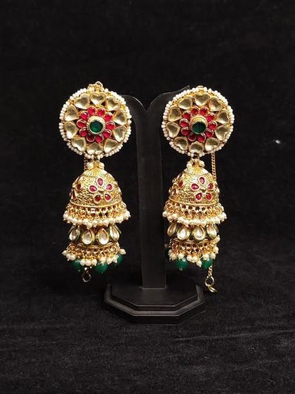 Another view of our classic red and green jhumkas, a popular rental choice for festive seasons.