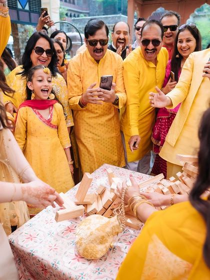 The pure joy and chaos of a giant Jenga game toppling over, surrounded by laughing family and friends.