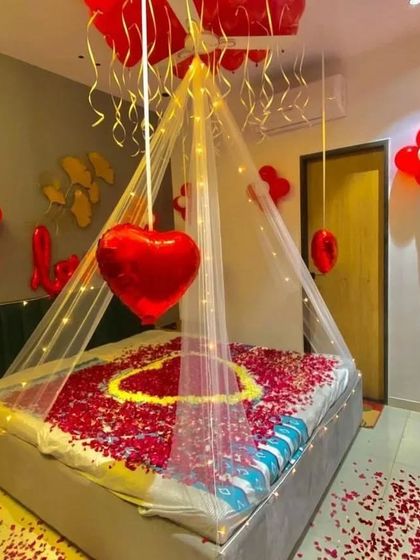Another view of the red and yellow rose petal heart cabana, with a floating heart-shaped balloon adding to the romantic ambiance.