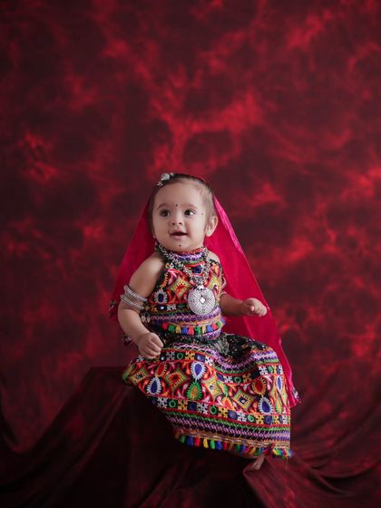 Another delightful shot from the Navratri baby shoot. Her happy expression and colorful outfit bring so much joy to the frame. These are the memories worth saving forever.