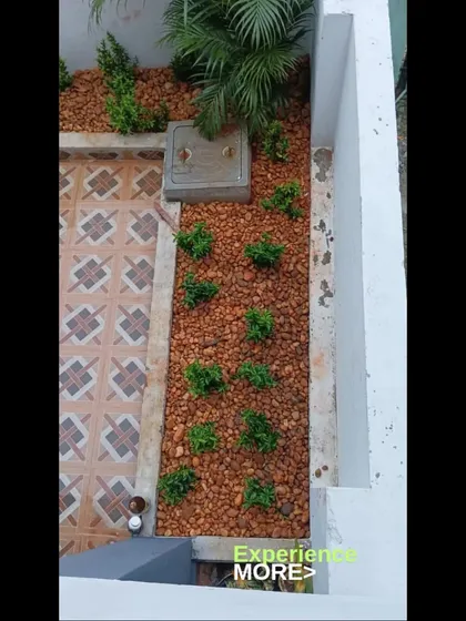 Another angle of the completed courtyard garden, showing how it neatly fits into the space next to the tiled patio. This type of small-scale landscaping is perfect for adding a touch of green without a big commitment.