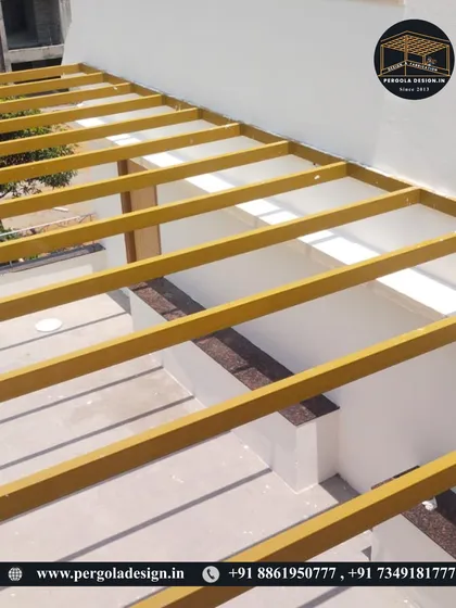 A close-up of the yellow-primed steel frame during the early stages of construction.