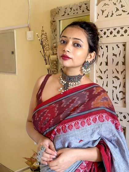 A close-up portrait in the Ikat saree. The oxidized silver choker is the perfect accessory for handloom sarees, adding to the earthy, artisanal vibe.
