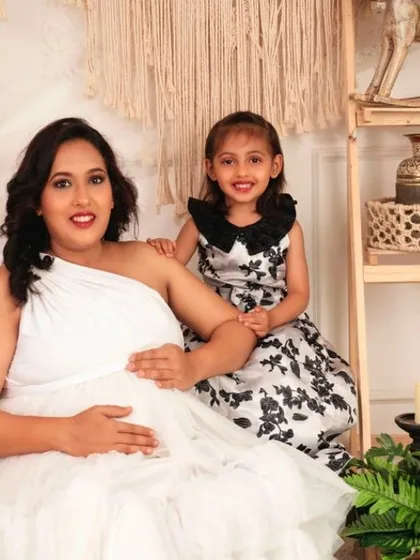 A sweet moment between a mother and her daughter, both excited to welcome the new baby.