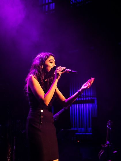 Bathed in purple light, a moment from one of our tour stops. We bring a professional and visually stunning show to every event.