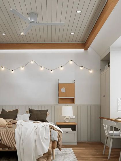 This cozy bedroom combines Scandinavian and rustic elements. The simple desk by the window, string lights, and wood-paneled ceiling create a warm and inviting atmosphere perfect for relaxing or working.