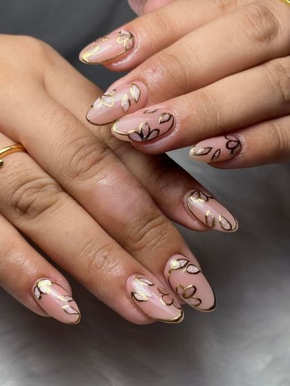 Another angle of the gold floral outline art, showing the consistency and precision of the line work.