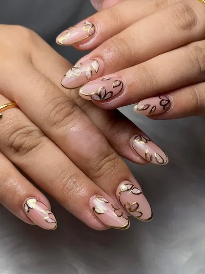 Another angle of the gold floral outline art, showing the consistency and precision of the line work.