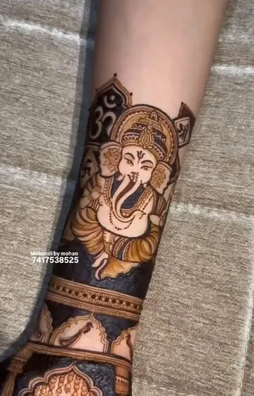A detailed portrait of Lord Ganesha on the forearm. This auspicious design is perfect for bringing blessings to any new beginning, be it a wedding, a new home, or a festival.
