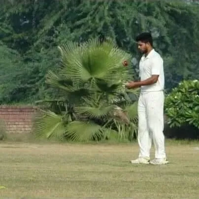 A player getting ready to deliver a spin bowl during a match. We offer specialized coaching for both pace and spin, ensuring we develop a well-rounded bowling attack.
