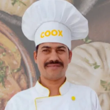 A portrait of one of our chefs specializing in Continental cuisine. He is part of our team of culinary experts who can elevate your home dining experience.