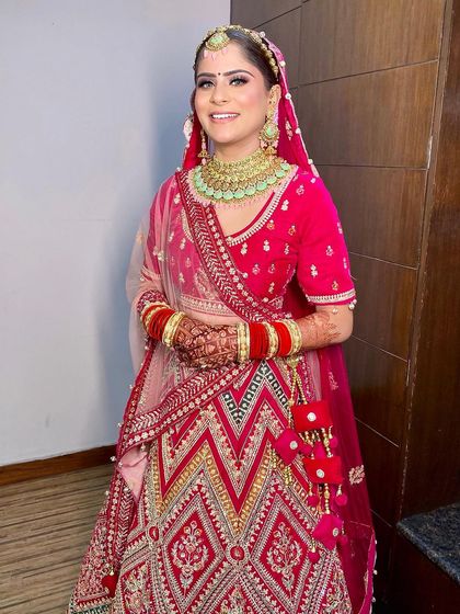 A full-length view of Gunjan's unique chevron-patterned lehenga, paired with a fresh and bright makeup look.