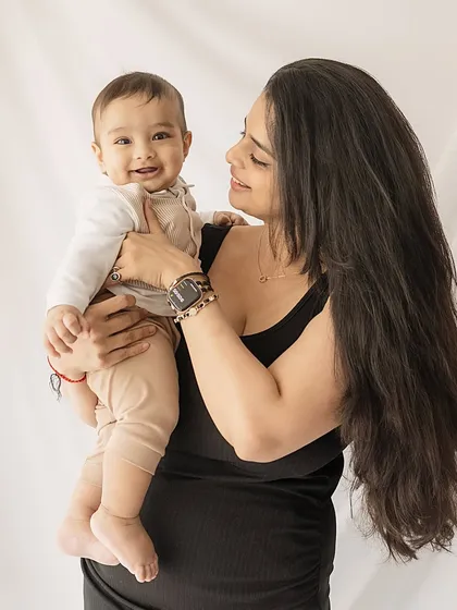 A tender portrait of a mother and her smiling baby.