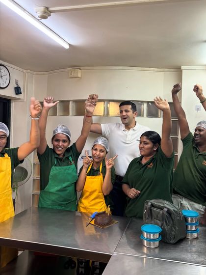 Pure joy and celebration! Our team raising their hands in excitement during our one-year anniversary. This is the energy that fuels our kitchen.