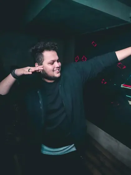 A fun, candid pose behind the decks that captures my playful personality.