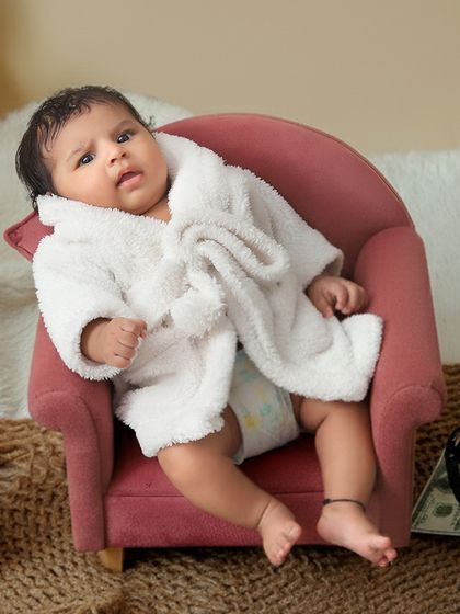 Another angle from our popular "spa day" theme, showing the baby looking relaxed and curious in a tiny armchair.