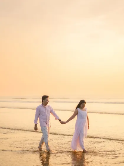 A classic romantic pre-wedding portrait taken during the golden hour at the beach. I use the soft, warm light of the sunset to create a dreamy and timeless image that focuses on the simple joy of a couple walking hand-in-hand by the sea.
