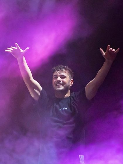 Martin Garrix emerging from a cloud of purple smoke, a simple but powerful stage effect that builds anticipation.