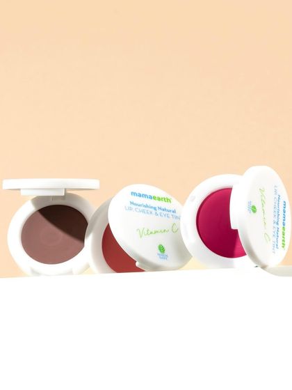 A clean, minimalist arrangement of lip tints. The composition is simple and elegant, allowing the products and their beautiful packaging to be the heroes of the shot.