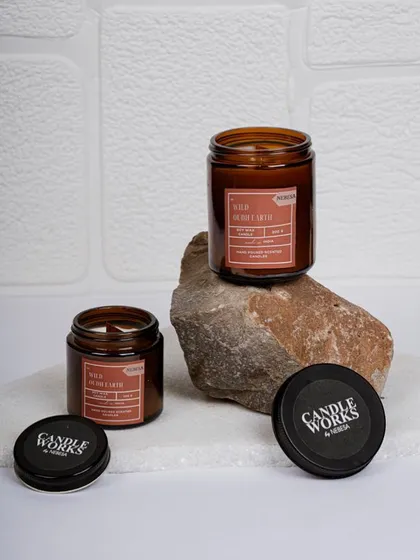 This "Wild Oudh Earth" scented jar candle is perfect for creating a grounding and calming atmosphere. The rich, woody scent is one of my signature fragrances, and the amber jar adds a touch of rustic elegance to your decor.