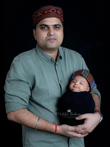 Adding a touch of heritage with a traditional Himachali cap for the baby, this portrait celebrates both family and culture.