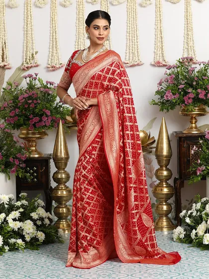 The full, standing view of the red Banarasi Bandhani saree, a quintessential piece for any bridal trousseau.