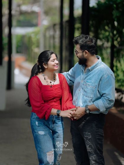 A couple holding hands and walking together, their smiles showing their easy and happy connection.