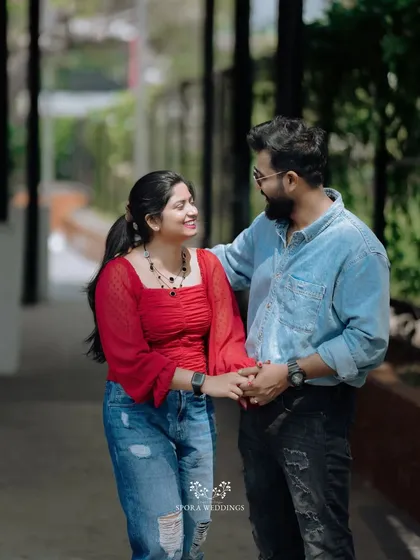 A couple holding hands and walking together, their smiles showing their easy and happy connection.