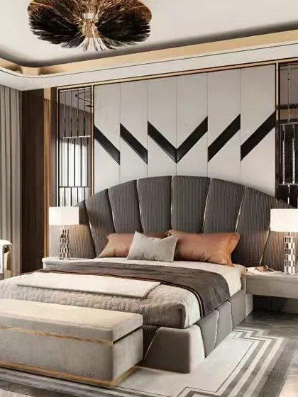 We crafted this luxurious master bedroom to feel like a high-end hotel suite. The design features a grand, fan-shaped upholstered headboard, sophisticated wall paneling with metallic accents, and custom bedside tables, all working together to create an atmosphere of pure elegance.