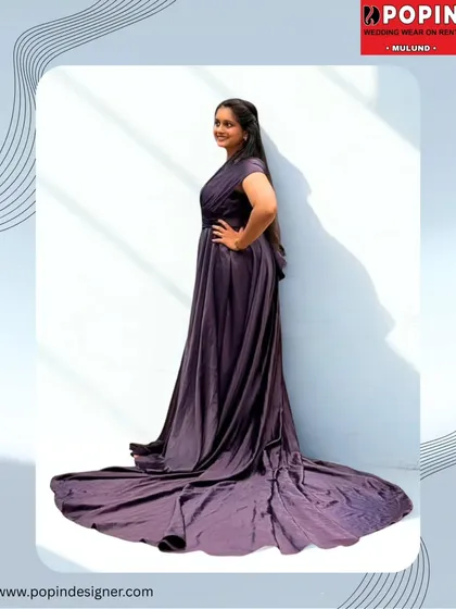 A side view of the purple satin gown, emphasizing the impressive length of its train. This gown is all about making a dramatic and stylish statement.