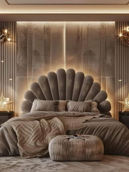 This cozy and luxurious bedroom setup features a plush, oversized comforter on a custom bed with a shell-shaped headboard. Star-shaped lights and warm ambient lighting create a relaxing and high-end feel.