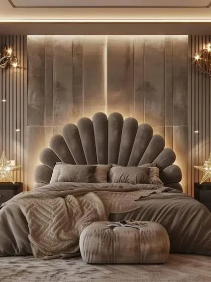 A close-up of a plush, velvet shell headboard with integrated lighting, paired with matching bedside tables and star-shaped wall sconces for a cohesive, luxurious feel.