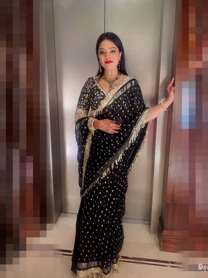 A classic black saree with gold sequin work is a timeless choice for a cocktail night or reception. It's the epitome of elegance and sophistication.