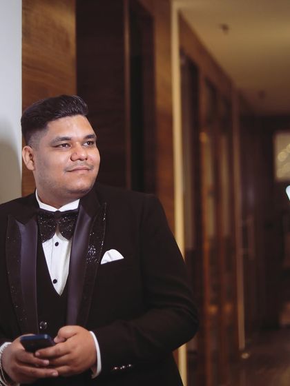 A client looking dapper in a classic three-piece tuxedo with embellished lapels. This is a timeless look for any formal event.