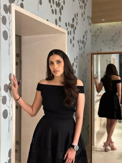 A classic little black dress from Alexander McQueen. The off-shoulder neckline and flared skirt make it a chic and timeless choice for any premiere or party.